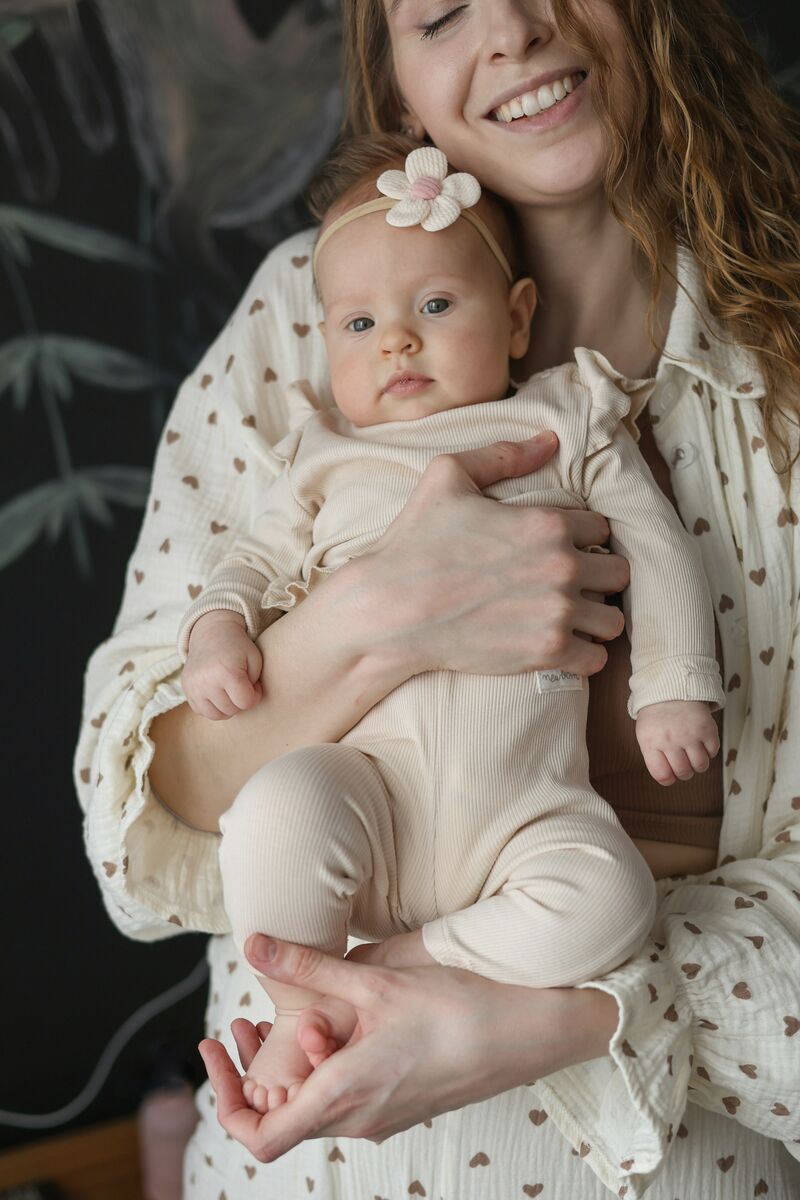 A smiling mother holding her baby close